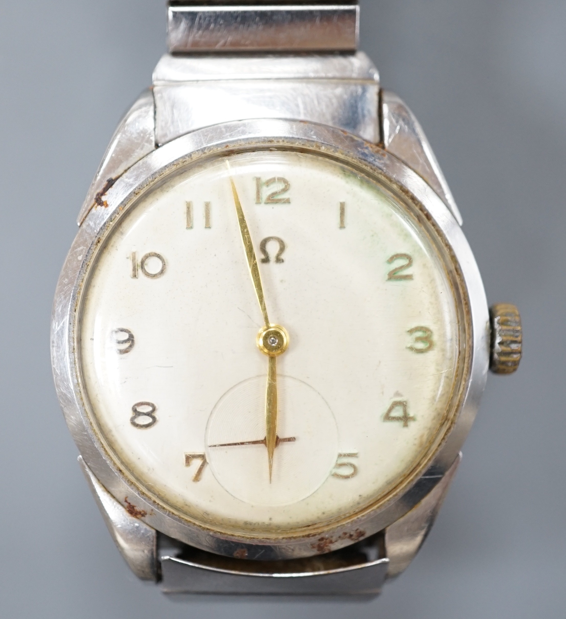 A gentleman's stainless steel Omega manual wind wrist watch, with Arabic dial and case back inscription, on associated flexible bracelet, case diameter 35mm.